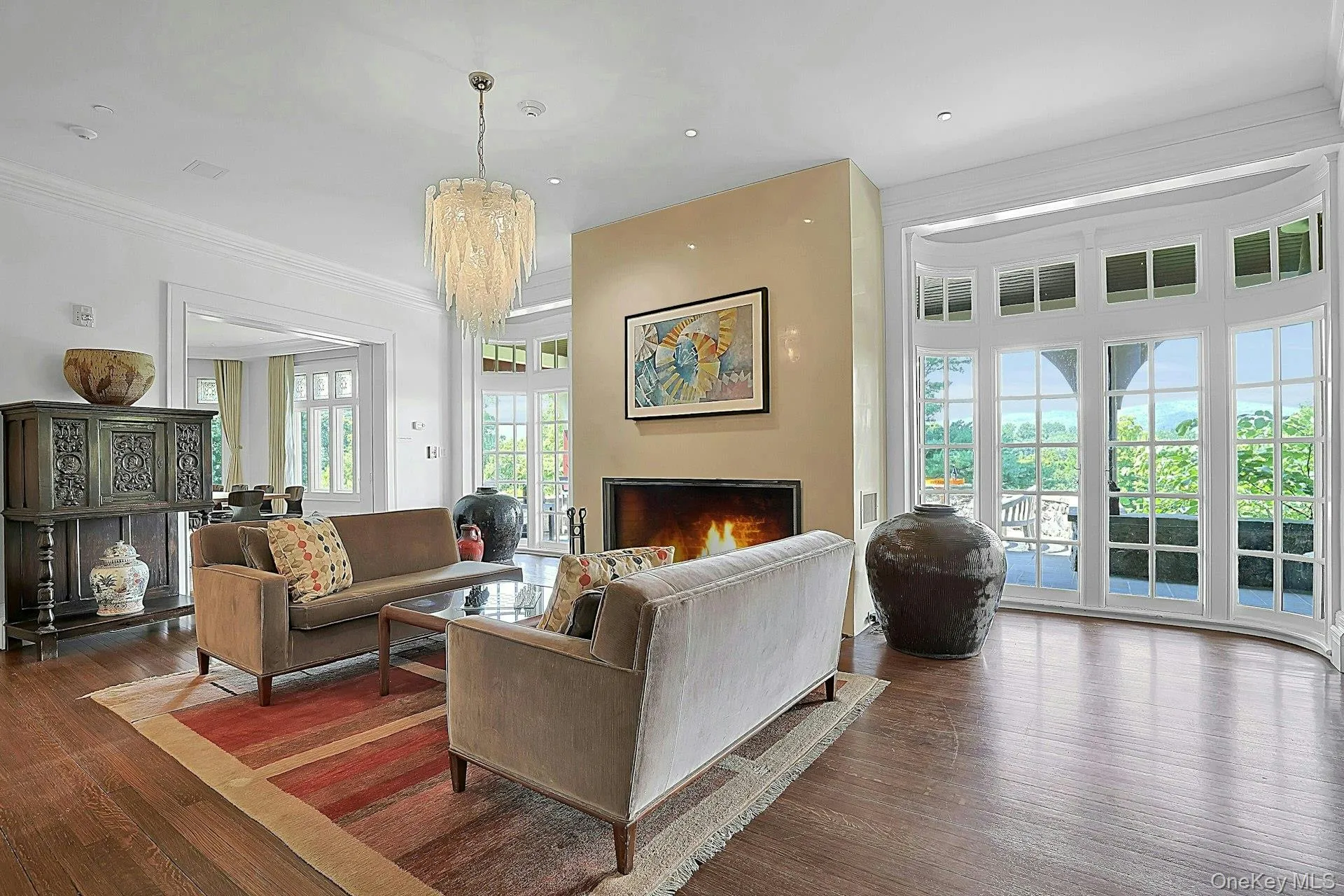 The formal living room, centered around a dramatic wood-burning fireplace, is the first thing to greet you upon entering the home. The original wood floors are solid and comfortable under foot. The formal living room, centered around a dramatic wood-burning fireplace, is the first thing to greet you upon entering the home. The original wood floors are solid and comfortable under foot.