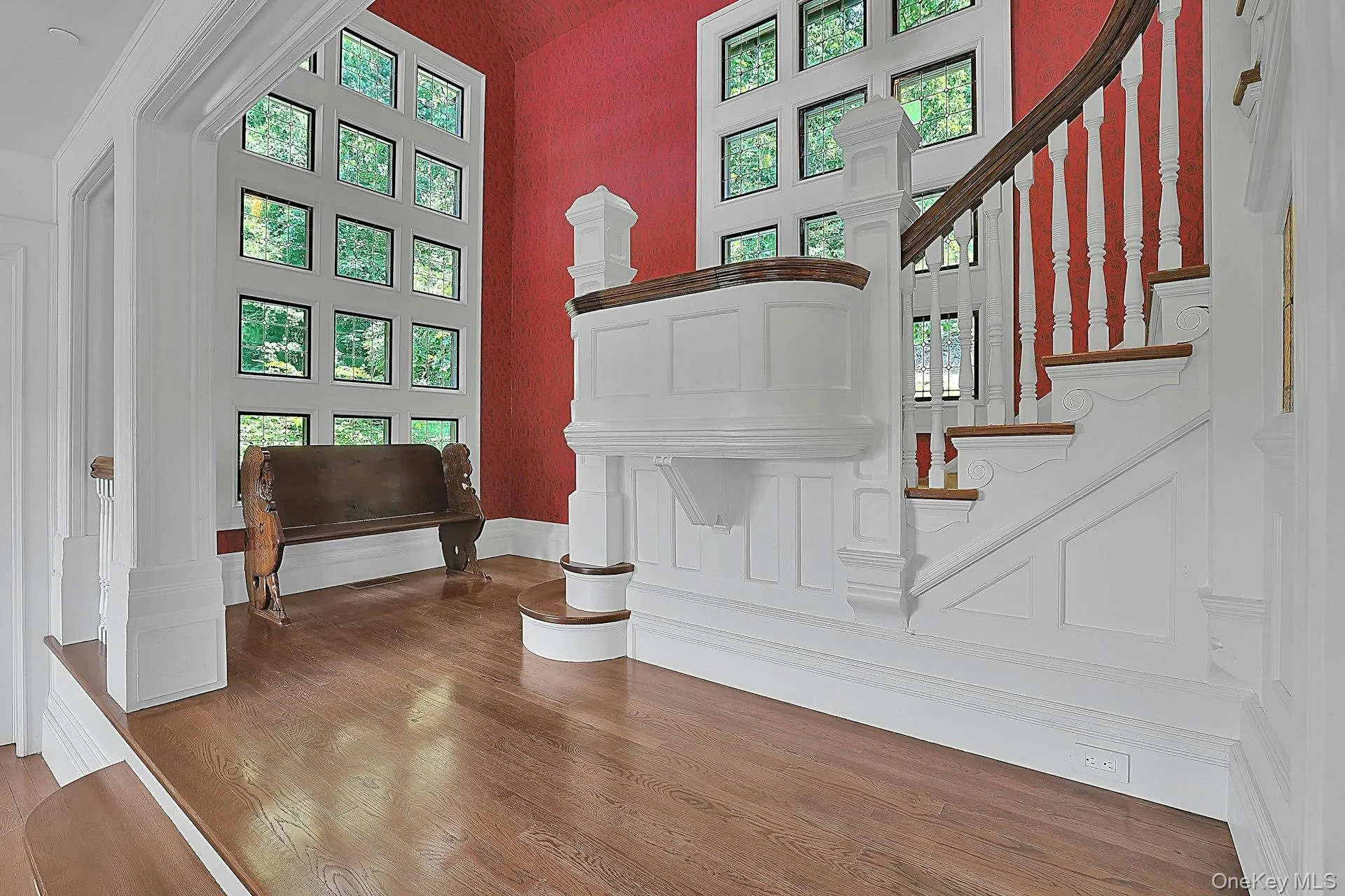 Walls of windows, with the leaded glass design preserved so well here, as throughout the rest of the home, welcome natural light to pour in and allows residents views of the beautiful, natural landscape beyond. There is a built-in bench on the other side of this staircase which would be another great reading nook. Walls of windows, with the leaded glass design preserved so well here, as throughout the rest of the home, welcome natural light to pour in and allows residents views of the beautiful, natural landscape beyond. There is a built-in bench on the other side of this staircase which would be another great reading nook.
