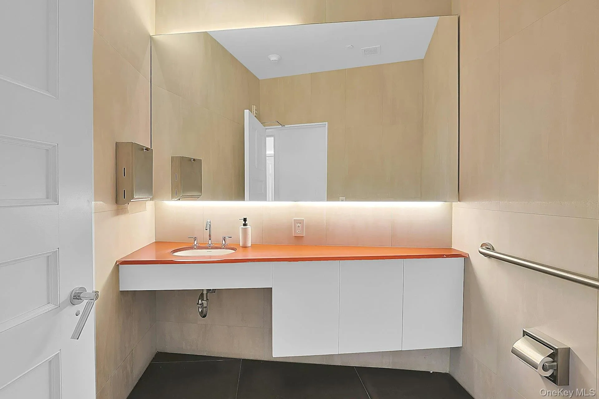 One of two first floor half bathrooms, this sleek, architect designed bathroom is something of a work of art. It feels like you are stepping into a museum installation when you enter this room. One of two first floor half bathrooms, this sleek, architect designed bathroom is something of a work of art. It feels like you are stepping into a museum installation when you enter this room.