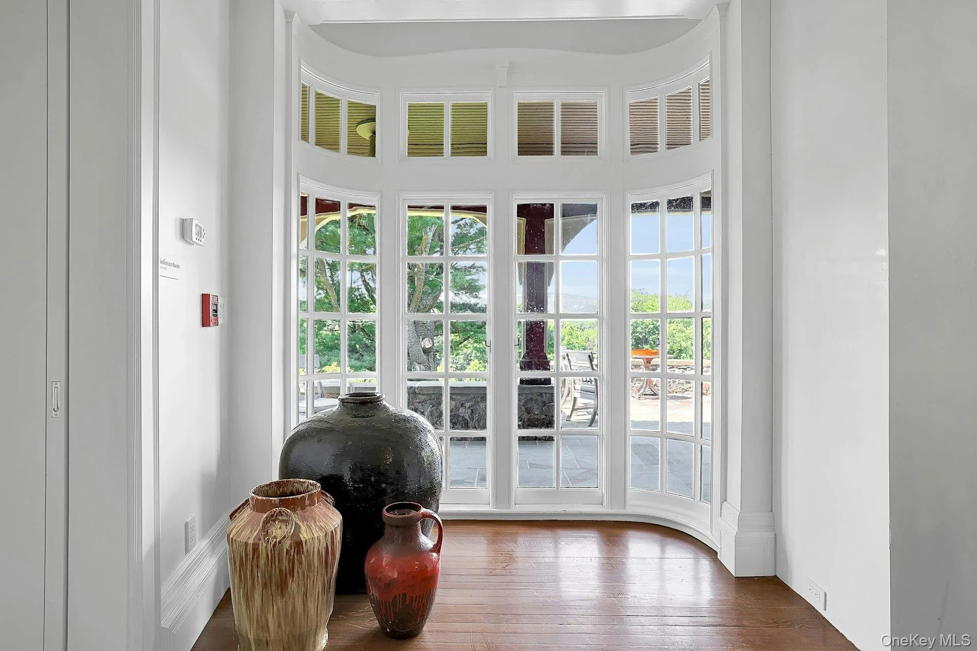 A closer look at the restored original 1800's doors, which open out to the large slate porch and patio beyond. Light shines off of the original hardwood floors. A closer look at the restored original 1800's doors, which open out to the large slate porch and patio beyond. Light shines off of the original hardwood floors.
