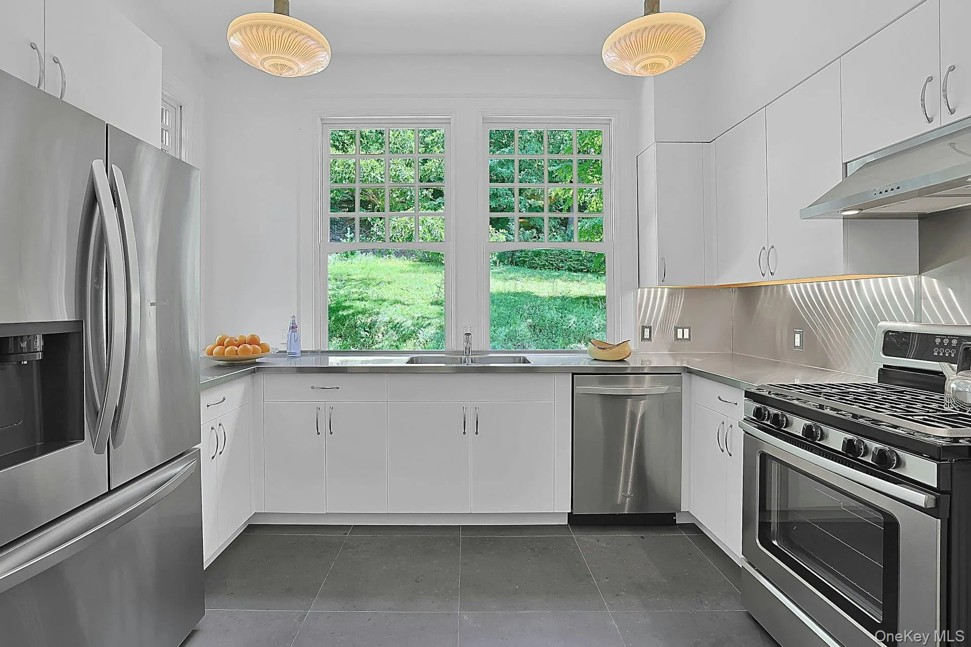 Four beautiful, matching glass fixtures cast warm light down. There is also convenient under-cabinet lighting here. There is ample cabinet space and the five burner stove can handle any recipe. Underfoot, the ceramic tile floor is easy to clean. Four beautiful, matching glass fixtures cast warm light down. There is also convenient under-cabinet lighting here. There is ample cabinet space and the five burner stove can handle any recipe. Underfoot, the ceramic tile floor is easy to clean.