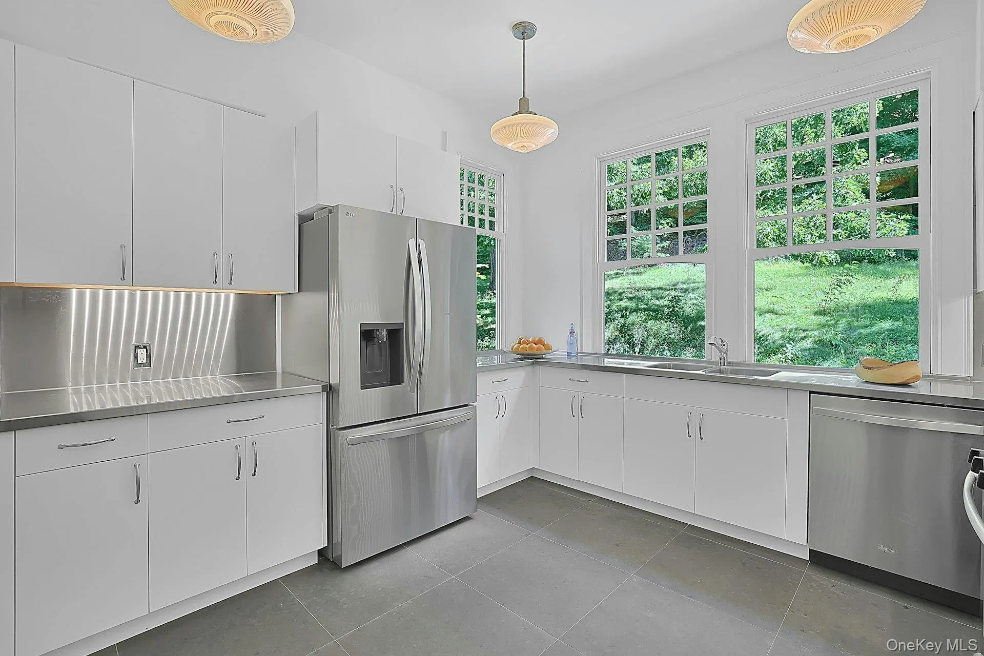 Just next door from the dining room is the chef's kitchen. The view out from the windows is gorgeous and calming, and the stainless appliances and counters make meal preparation here a dream - and cleaning up afterward easy! Just next door from the dining room is the chef's kitchen. The view out from the windows is gorgeous and calming, and the stainless appliances and counters make meal preparation here a dream - and cleaning up afterward easy!