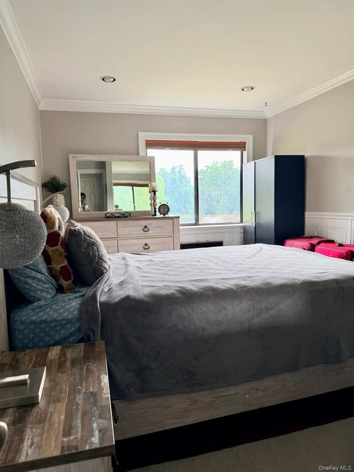 This bedroom offers a light and airy feel with modern essentials, Recessed lighting ,crown molding, and attractive wains -coating to showcase a finished sleeping quarters. This bedroom offers a light and airy feel with modern essentials, Recessed lighting ,crown molding, and attractive wains -coating to showcase a finished sleeping quarters.