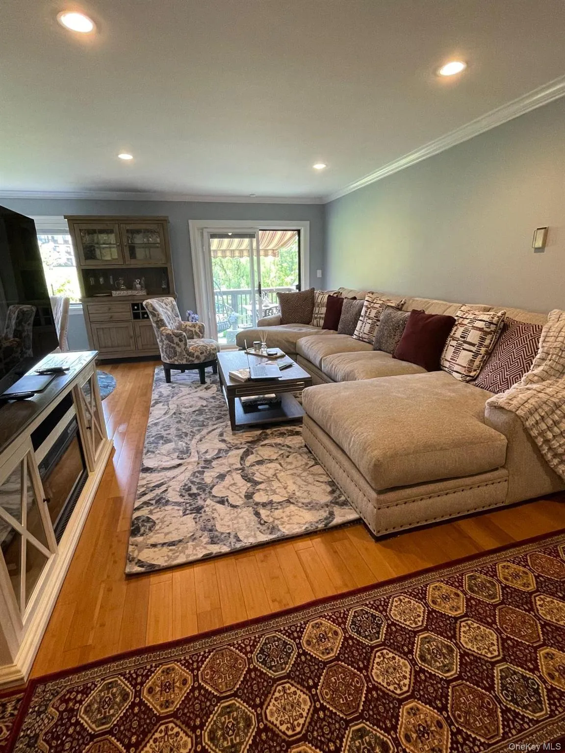 Get comfortable in this large living room with recess lighting and crown molding. Get comfortable in this large living room with recess lighting and crown molding.