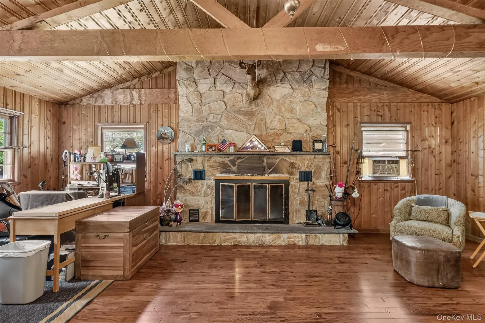 Enormous Living Room with floor to ceiling stone fireplace, hardwood floors and beams Enormous Living Room with floor to ceiling stone fireplace, hardwood floors and beams
