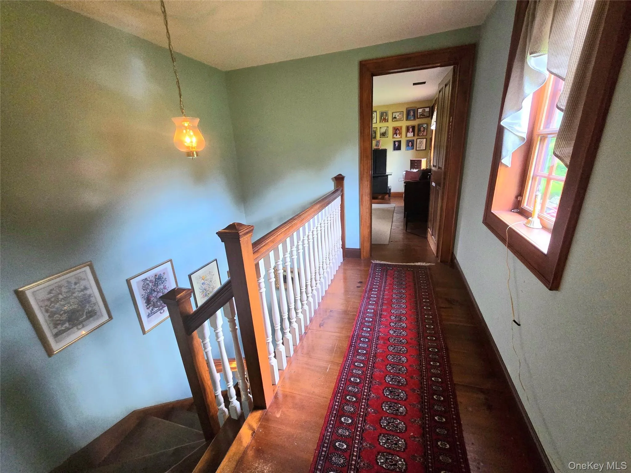 Wood flooring with a paneled staircase and wooden newel post Wood flooring with a paneled staircase and wooden newel post
