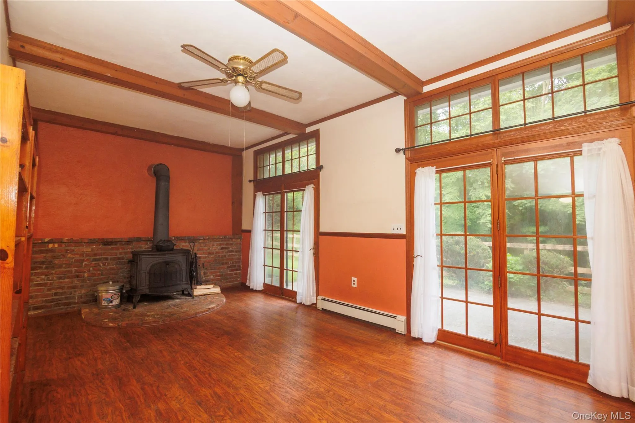 Living room in lower level apartment with wood burning stove. Living room in lower level apartment with wood burning stove.