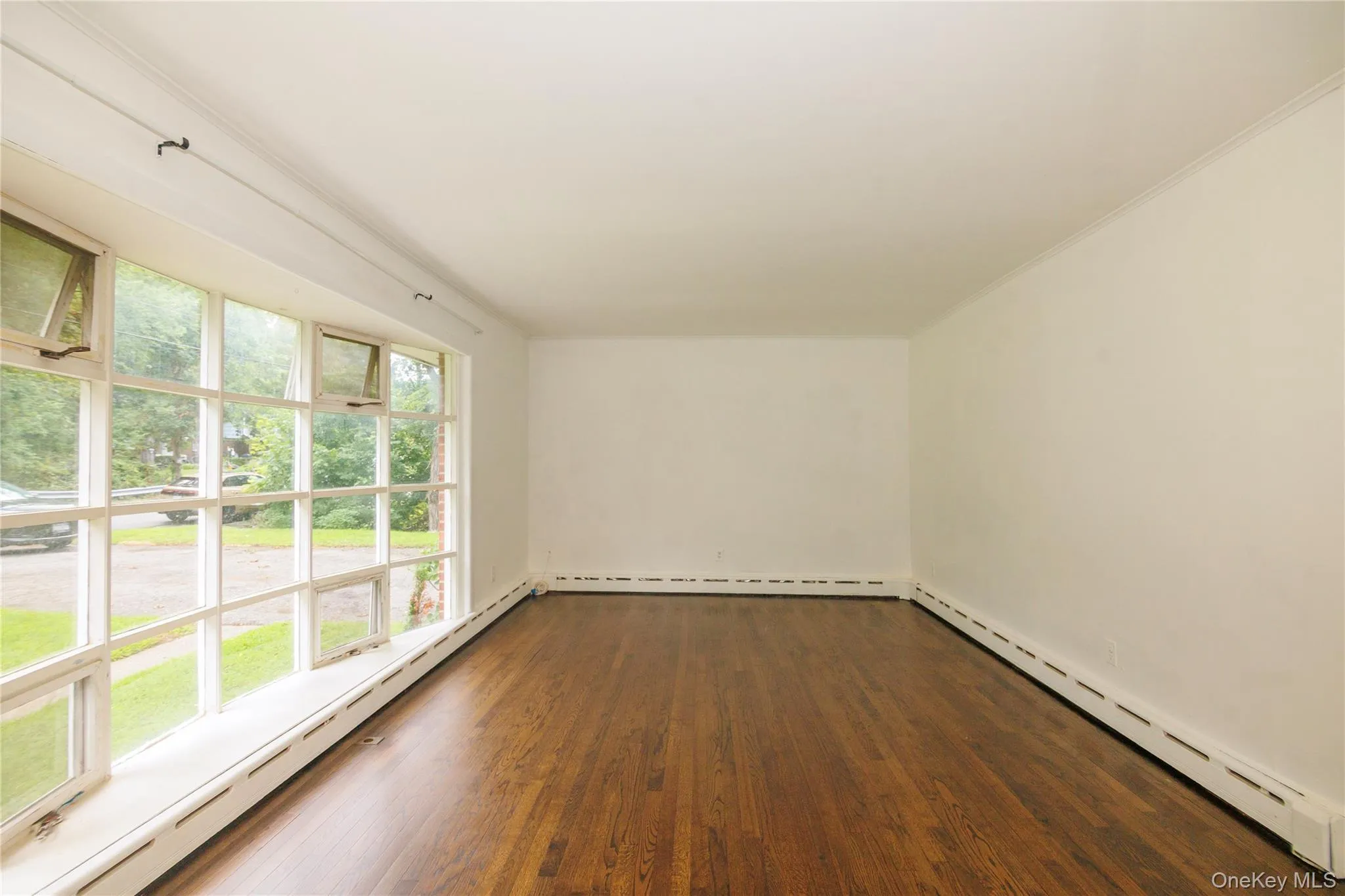 Living room with all redone hardwood floors throughout the house. Living room with all redone hardwood floors throughout the house.