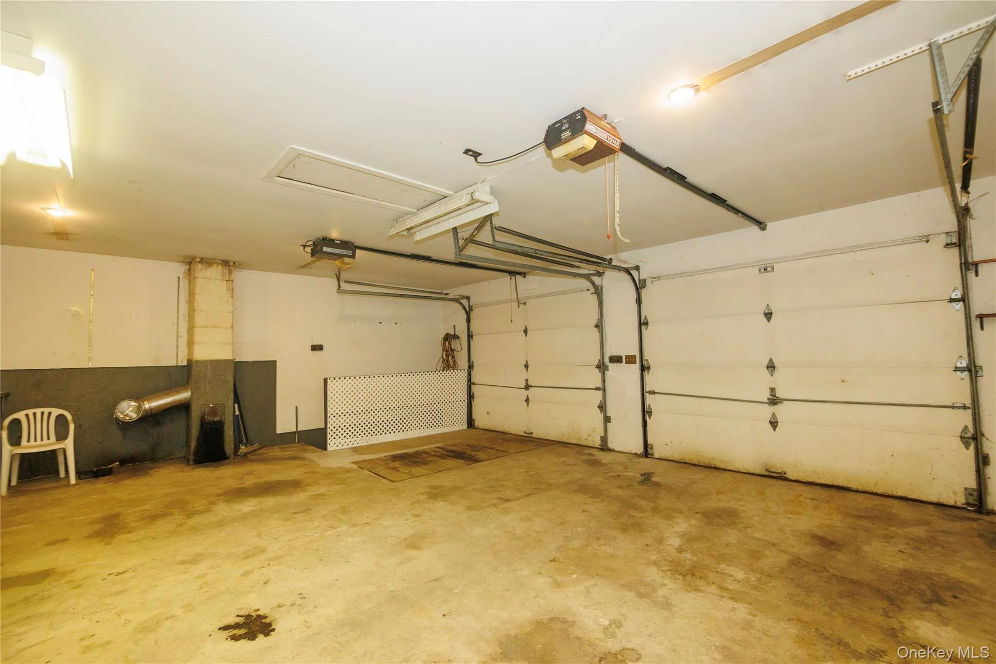 Large two car garage with electric doors. One side has removable boards for a pit to work on car. Large two car garage with electric doors. One side has removable boards for a pit to work on car.