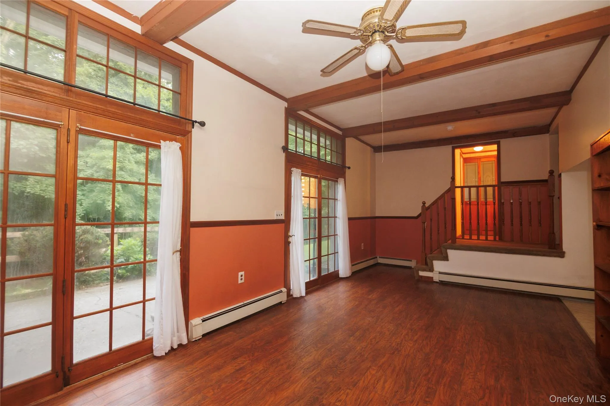 Two French door leading to patio in lower level apartment. To the right is a dinning room. Two French door leading to patio in lower level apartment. To the right is a dinning room.