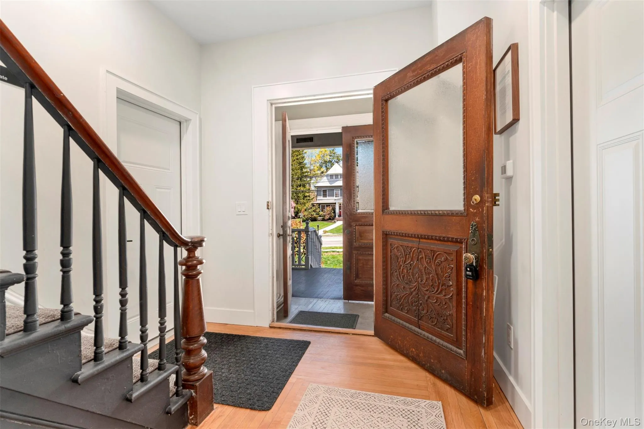 Entrance foyer with baseboards, light wood-style floors, and stairs Entrance foyer with baseboards, light wood-style floors, and stairs
