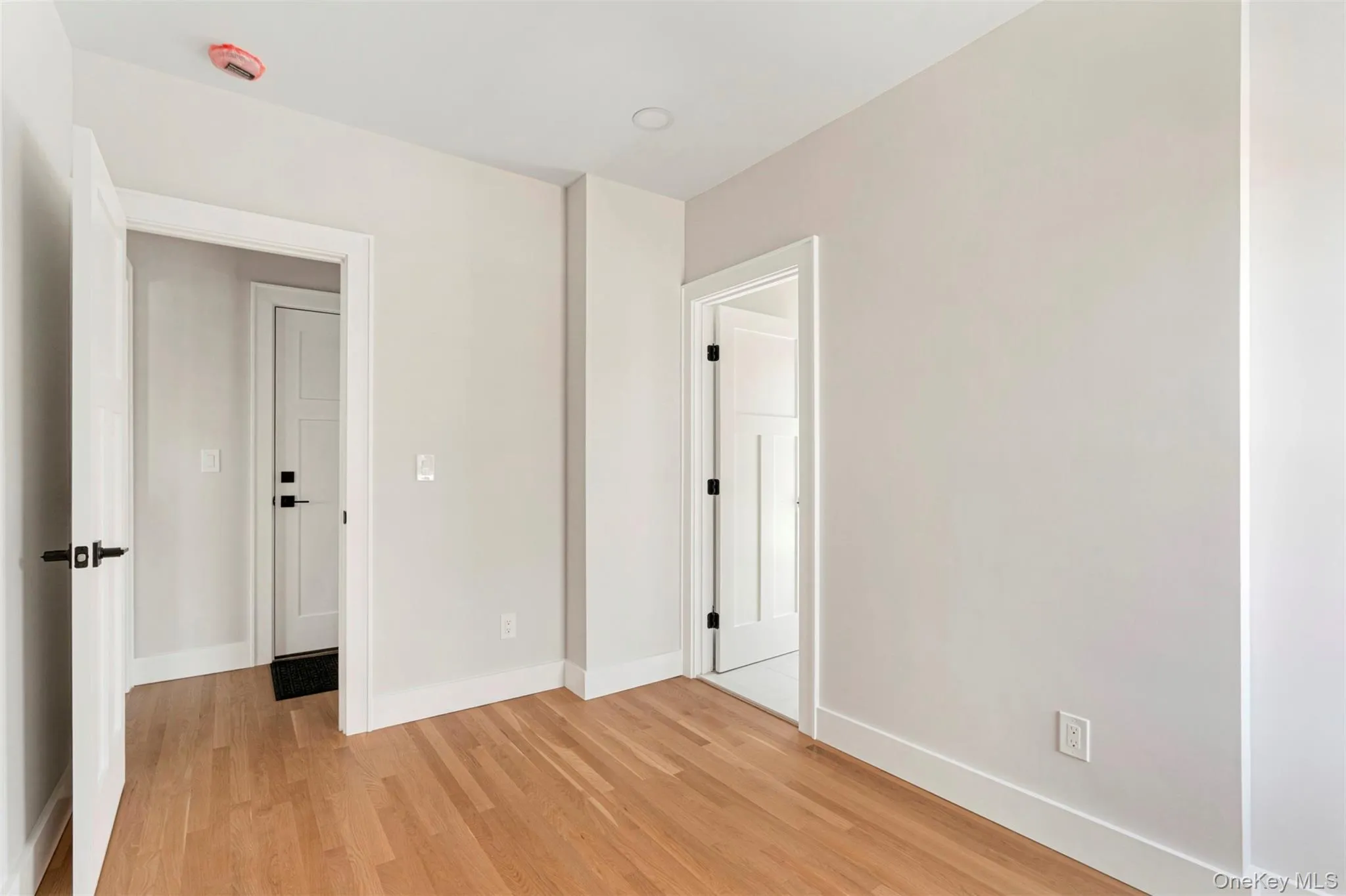 Unfurnished bedroom featuring baseboards and light wood-style flooring Unfurnished bedroom featuring baseboards and light wood-style flooring