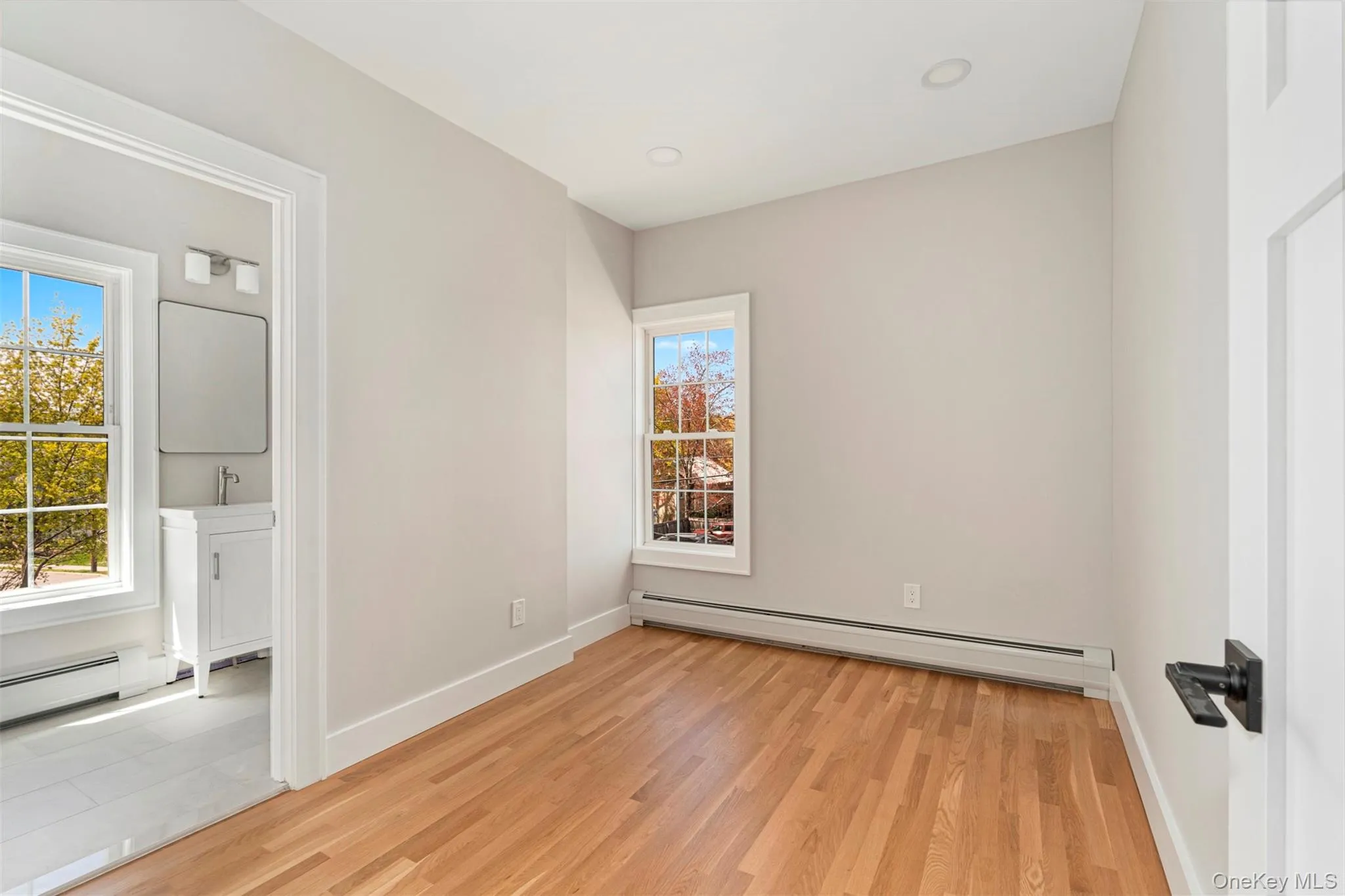 Unfurnished bedroom featuring baseboards and light wood-style flooring Unfurnished bedroom featuring baseboards and light wood-style flooring