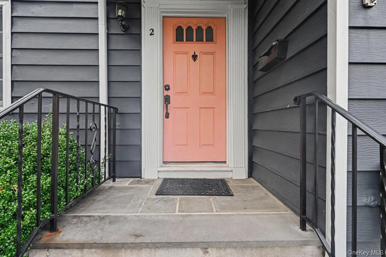 Blue stone stairs and walkway with handrail lead to a covered front entry. Blue stone stairs and walkway with handrail lead to a covered front entry.