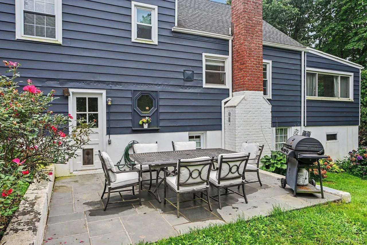 Blue stone patio has door to the lower level. Blue stone patio has door to the lower level.