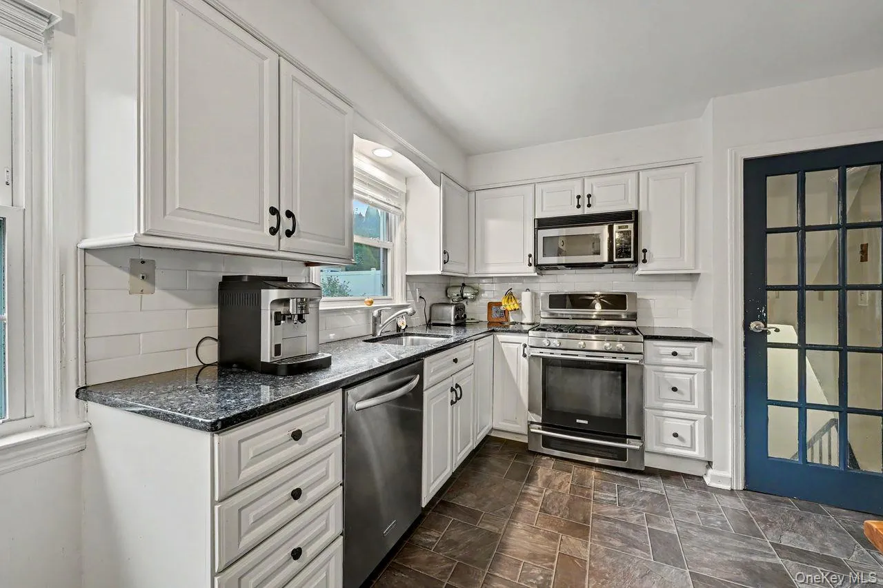 A chef's delight...white cabinets, granite counter top and stainless steel appliances. door leads to the lower level. A chef's delight...white cabinets, granite counter top and stainless steel appliances. door leads to the lower level.