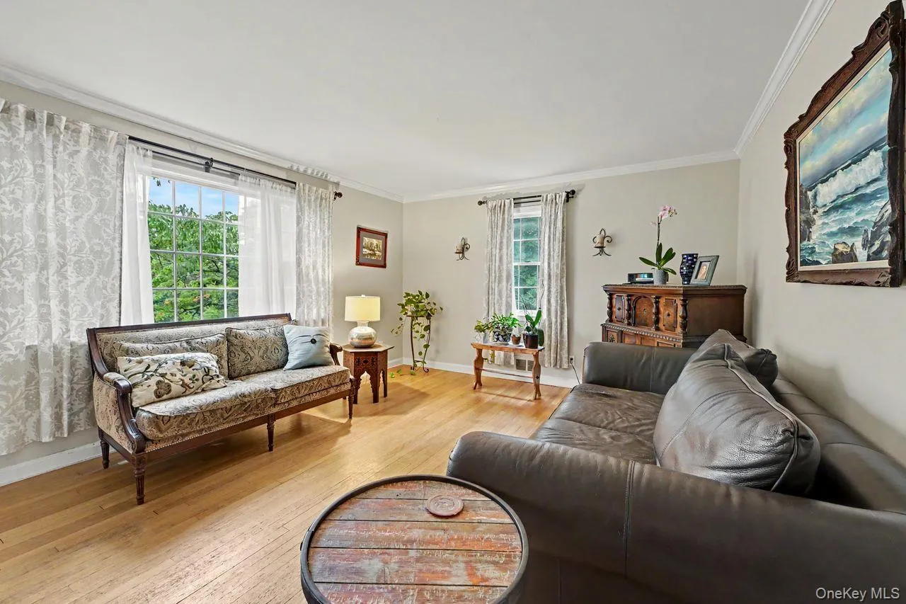 Wood floors and triple window enhance the sunlit living room. Wood floors and triple window enhance the sunlit living room.