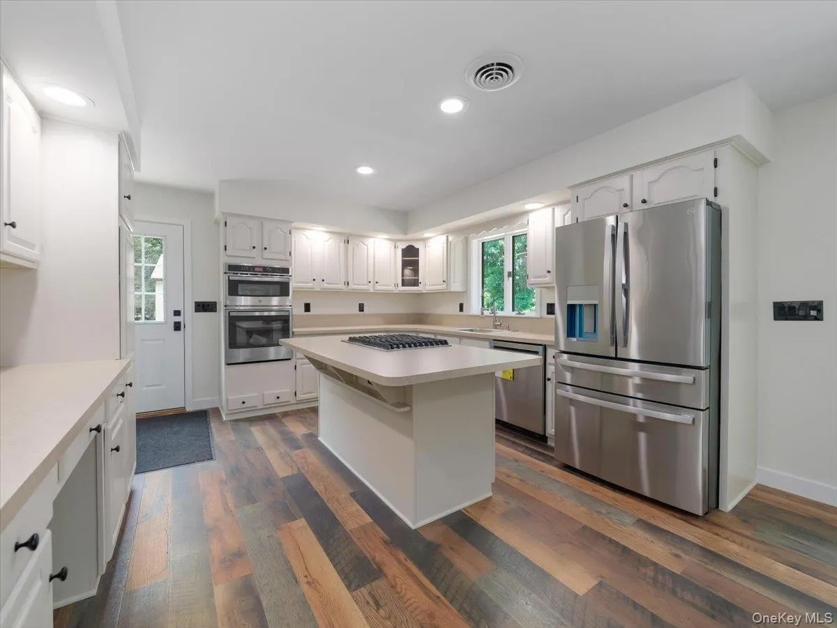 View of kitchen and door to side deck all new appliances View of kitchen and door to side deck all new appliances