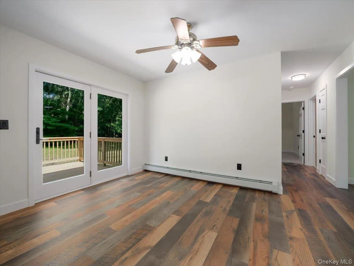 Doors to deck in dining room area- hall to bedrooms on right Doors to deck in dining room area- hall to bedrooms on right