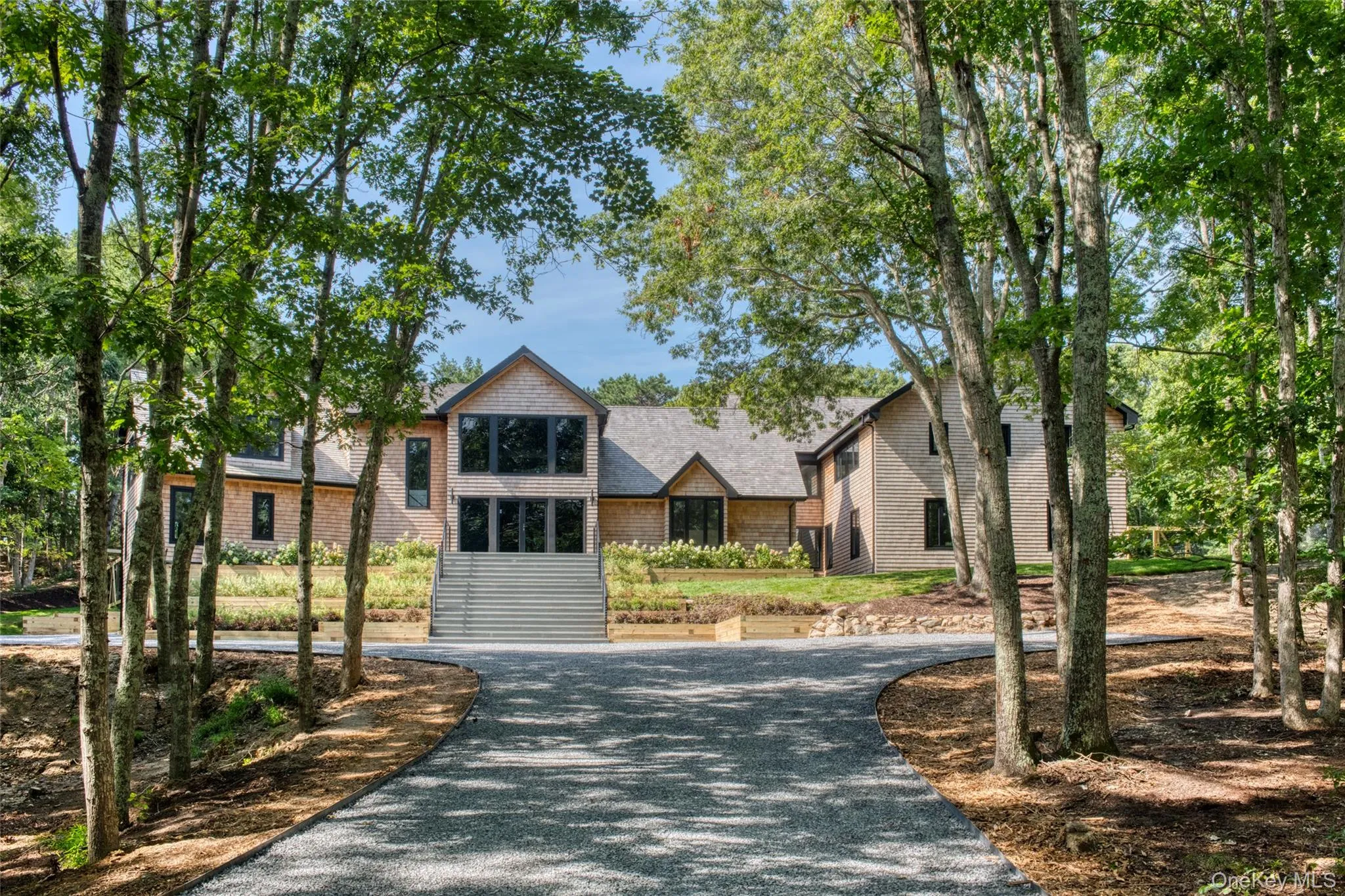 Shingle-sided exterior with a natural wood roof and dark-framed windows Shingle-sided exterior with a natural wood roof and dark-framed windows
