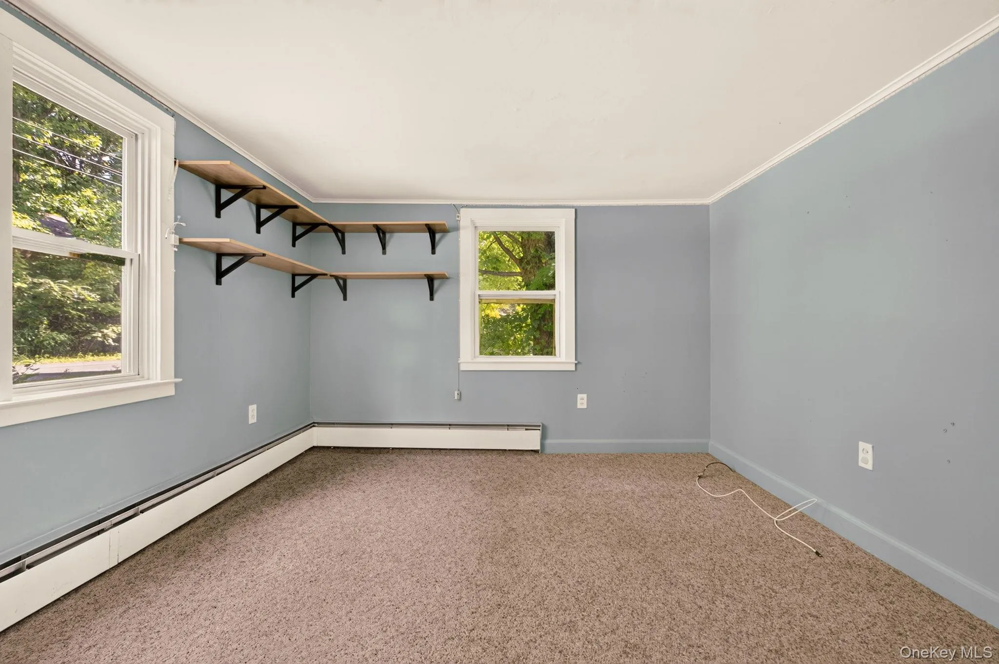 Corner built-in shelving, white trim, and light blue walls Corner built-in shelving, white trim, and light blue walls