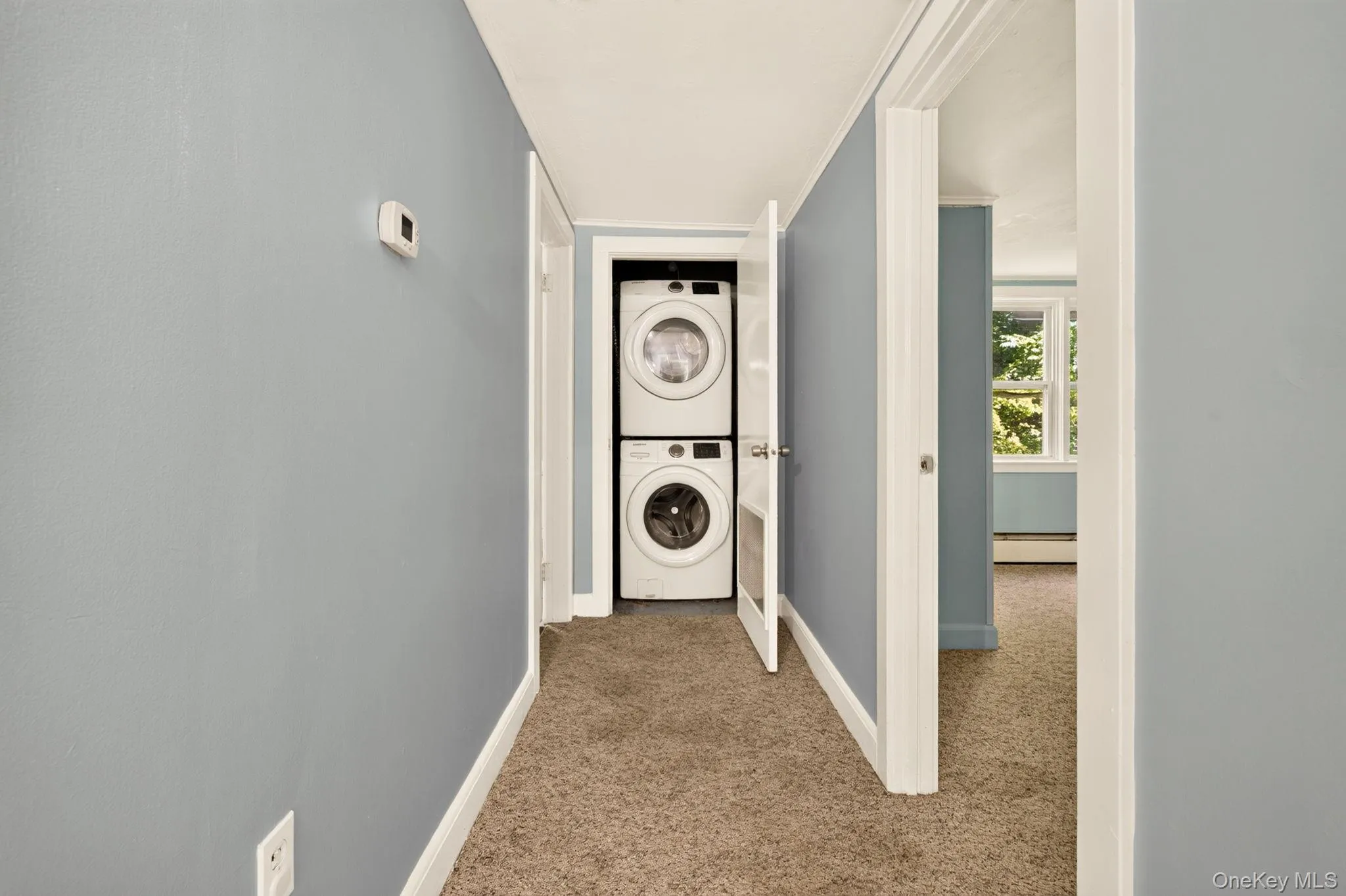 Stackable laundry appliances within a dedicated closet Stackable laundry appliances within a dedicated closet
