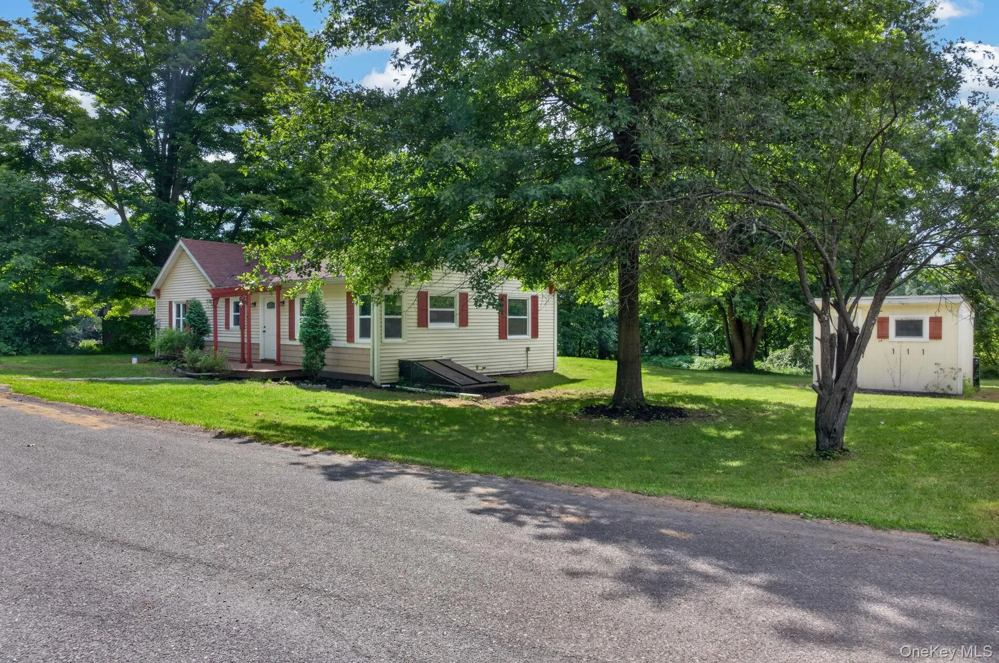 Charming cottage-style home set on a spacious, tree-lined lot with mature oak trees providing natural shade Charming cottage-style home set on a spacious, tree-lined lot with mature oak trees providing natural shade