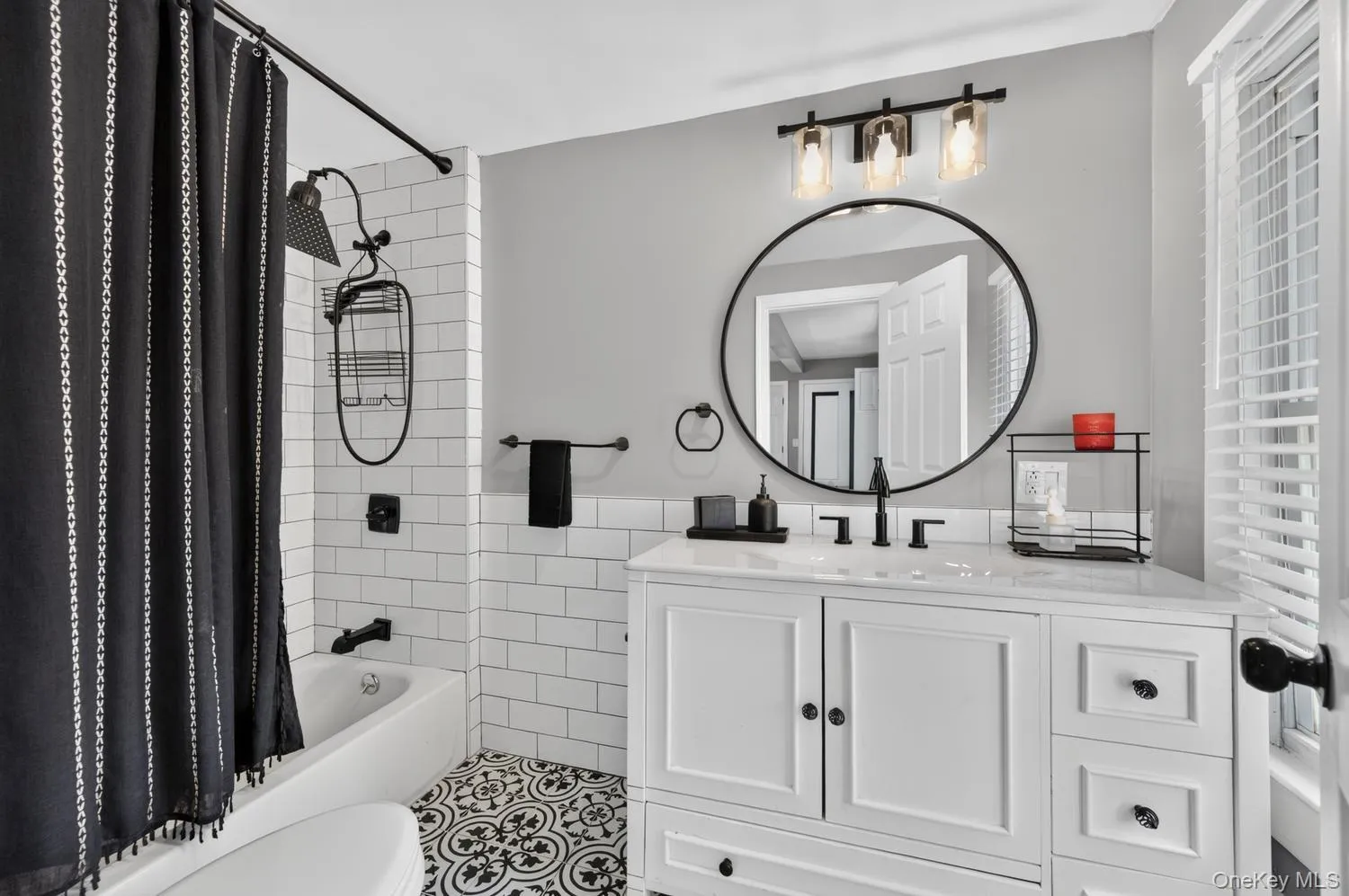 Full bath with subway tile shower, rain showerhead and decorative tile flooring Full bath with subway tile shower, rain showerhead and decorative tile flooring