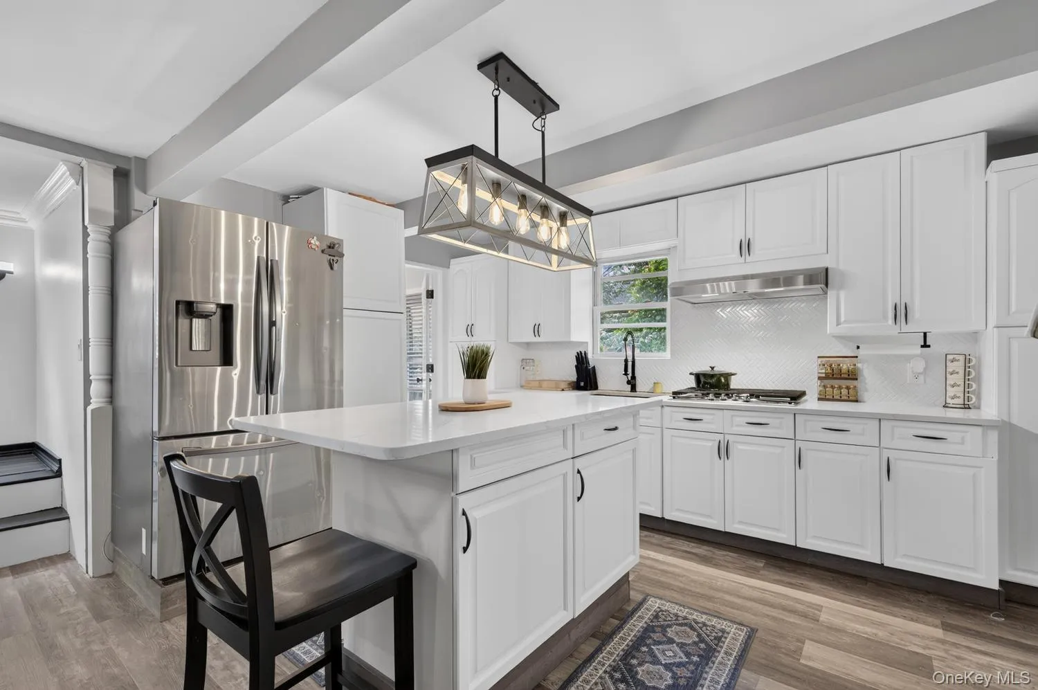 Bright and airy kitchen with white cabinetry and stainless steel appliances Bright and airy kitchen with white cabinetry and stainless steel appliances