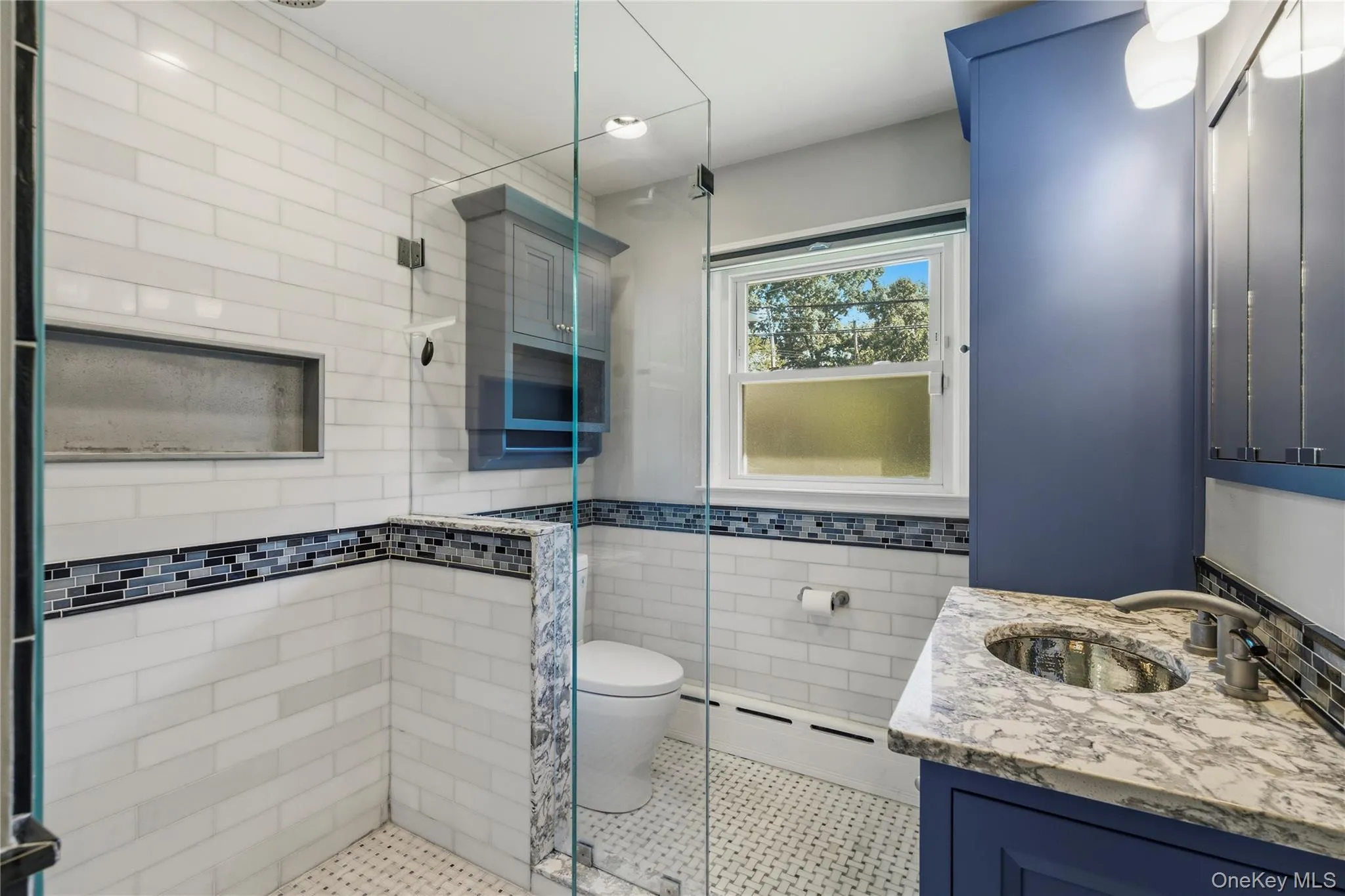 Glass-enclosed shower with white subway tile Glass-enclosed shower with white subway tile