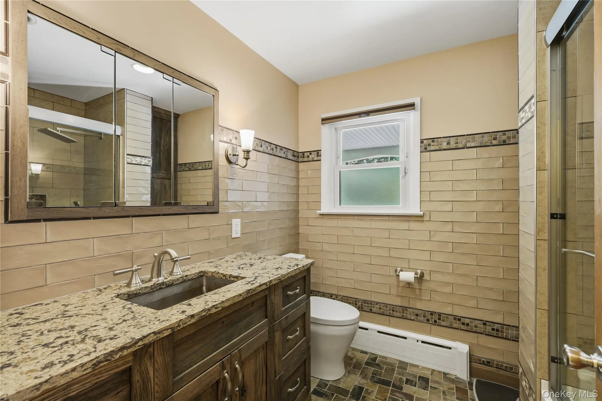 Wood-finish vanity with a stone countertop and undermount sink Wood-finish vanity with a stone countertop and undermount sink