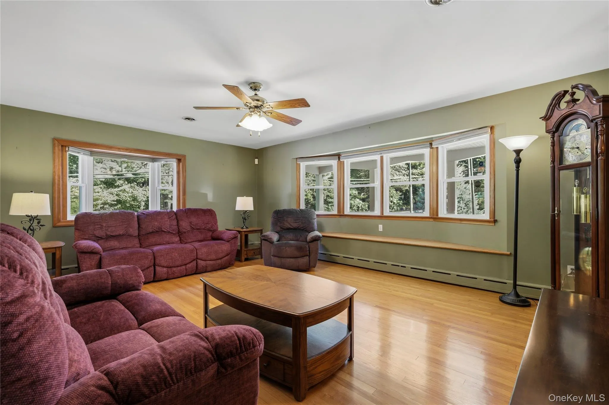 Hardwood flooring, bay window, multiple windows, ceiling fan, and built-in window ledge Hardwood flooring, bay window, multiple windows, ceiling fan, and built-in window ledge