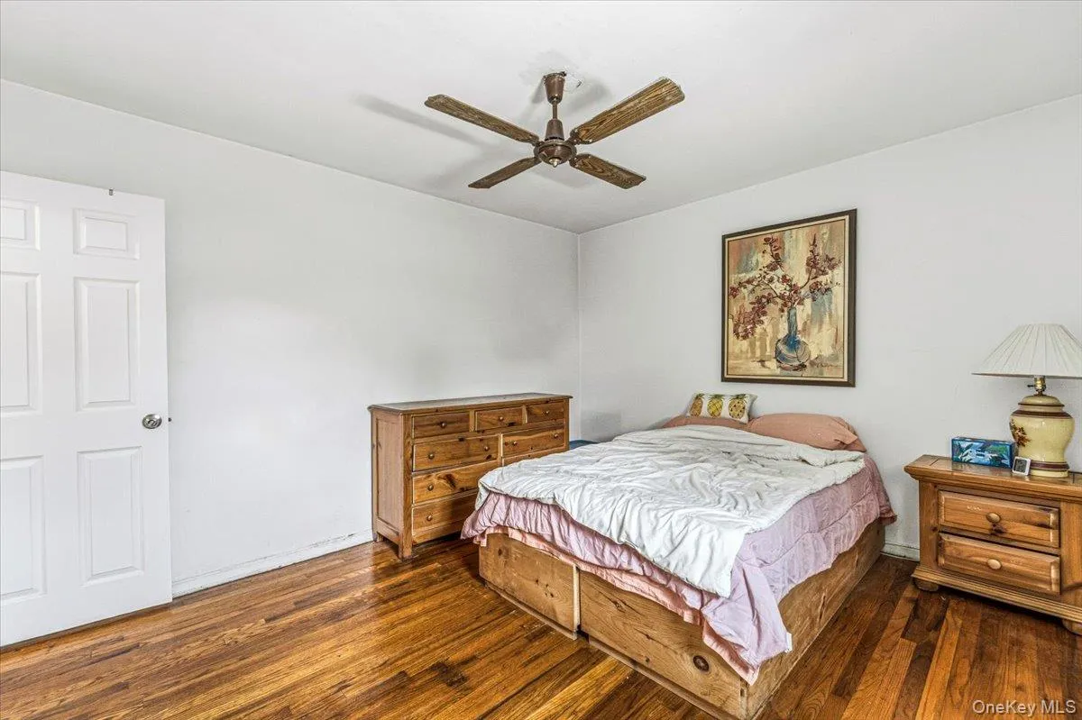 Hardwood flooring, painted walls, ceiling fan, and paneled door Hardwood flooring, painted walls, ceiling fan, and paneled door