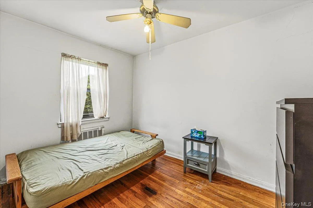 Hardwood flooring, window with natural light, and a ceiling fan with integrated lighting Hardwood flooring, window with natural light, and a ceiling fan with integrated lighting