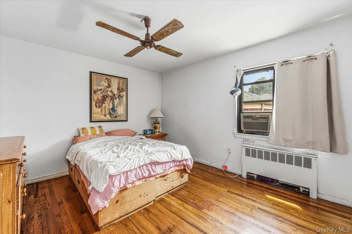 Hardwood flooring, window with exterior exposure, ceiling fan, and white walls Hardwood flooring, window with exterior exposure, ceiling fan, and white walls
