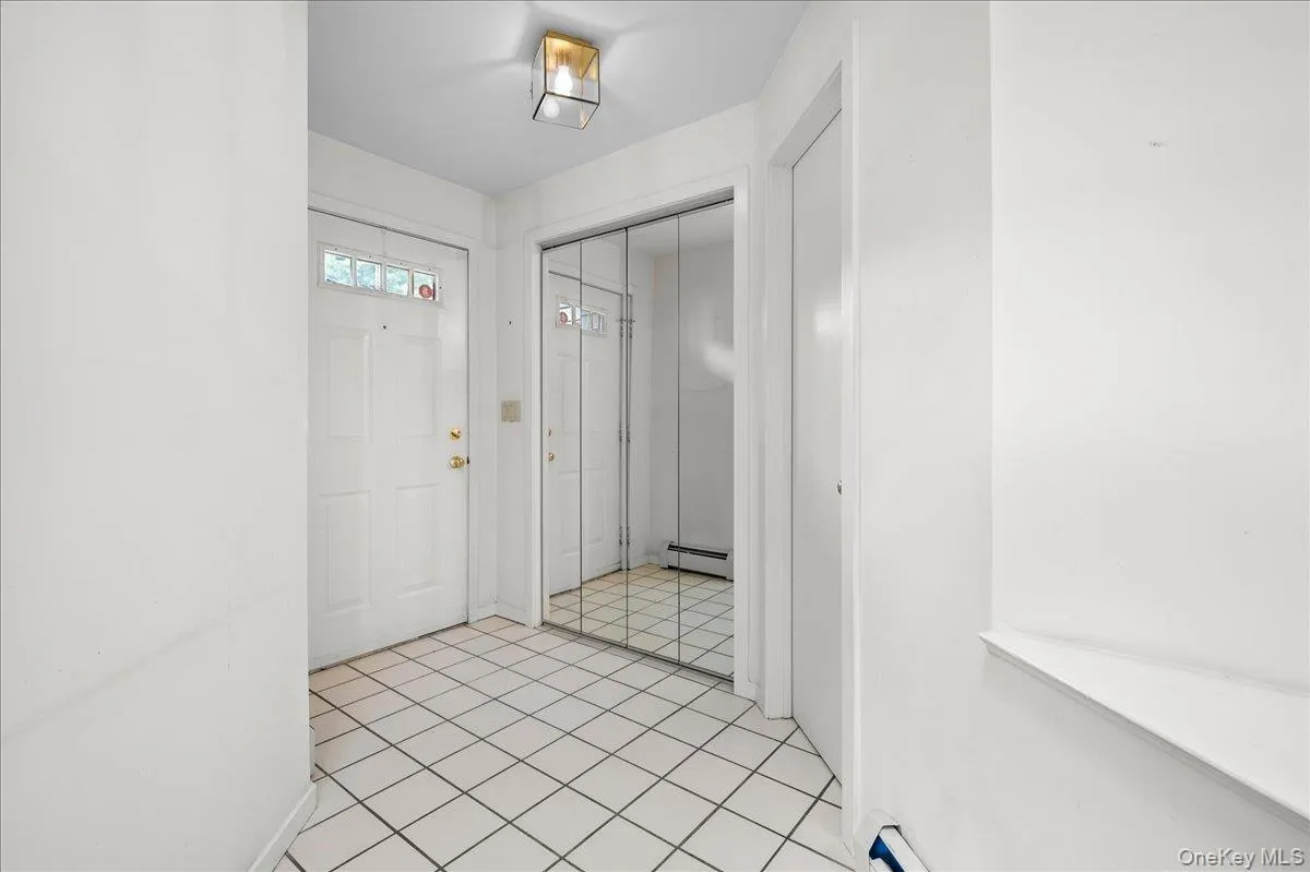 View that looks onto the front door and first floor half bath View that looks onto the front door and first floor half bath