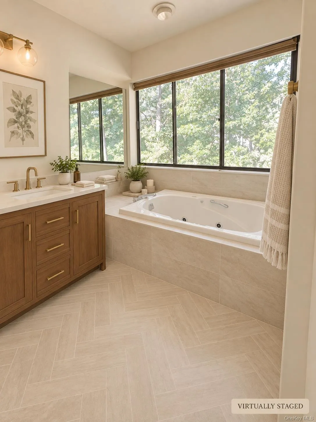 Herringbone tile flooring, a built-in jetted tub, a wood-finish vanity with a stone countertop, a large mirror, and ample natural light from extensive windows Herringbone tile flooring, a built-in jetted tub, a wood-finish vanity with a stone countertop, a large mirror, and ample natural light from extensive windows