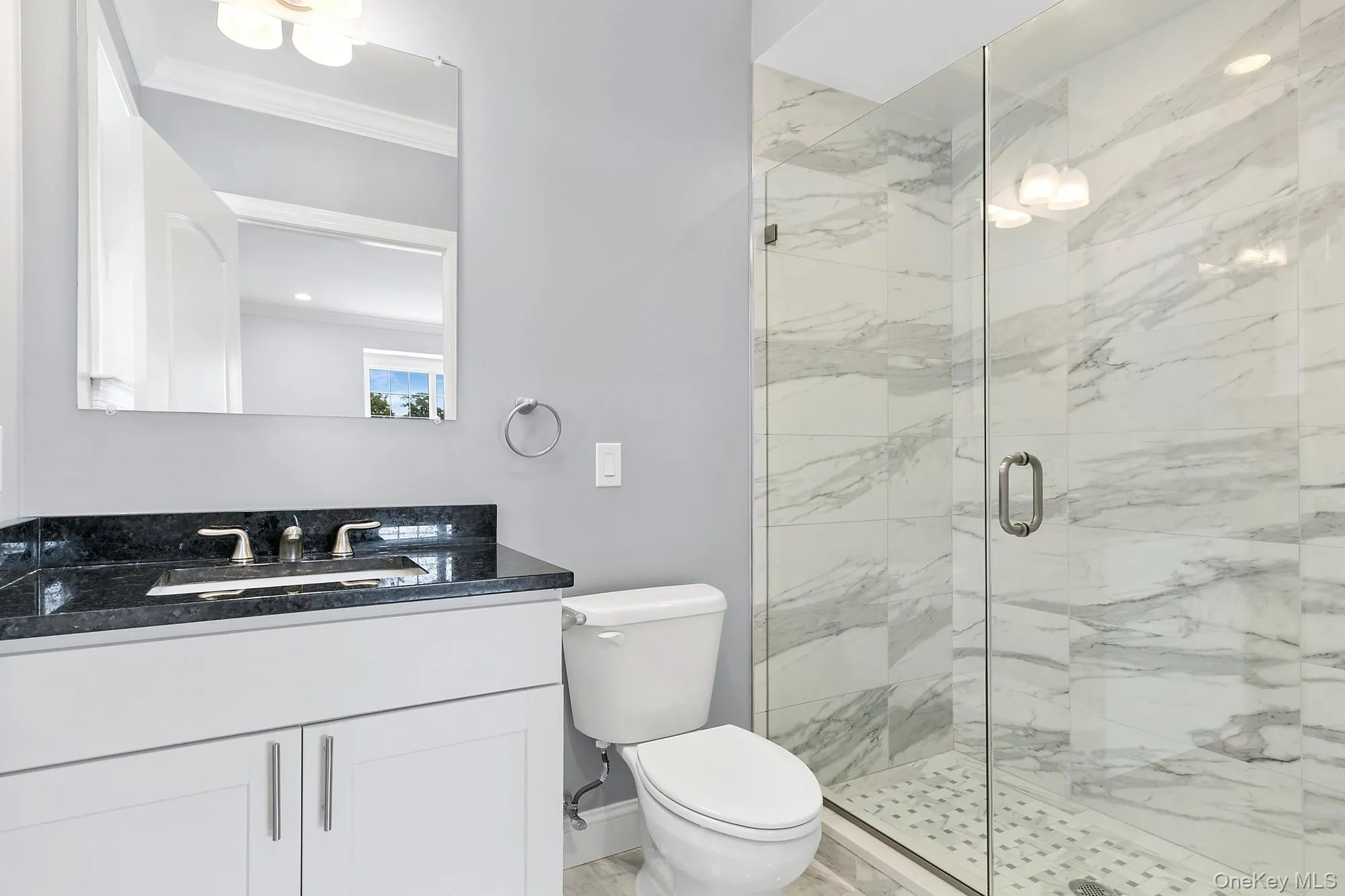 Primary Bathroom featuring ornamental molding, vanity, toilet, and an enclosed shower Primary Bathroom featuring ornamental molding, vanity, toilet, and an enclosed shower