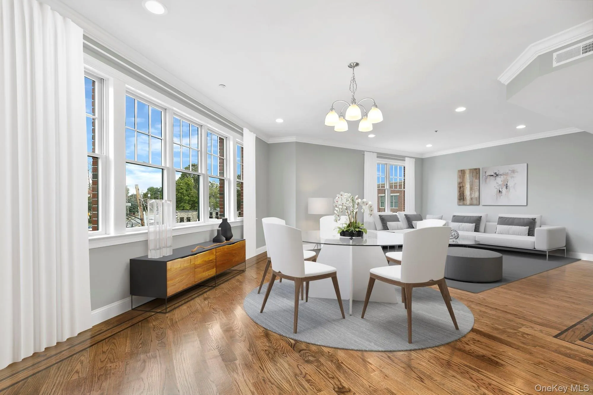 Dining space with crown molding, an inviting chandelier, and wood-type flooring Dining space with crown molding, an inviting chandelier, and wood-type flooring