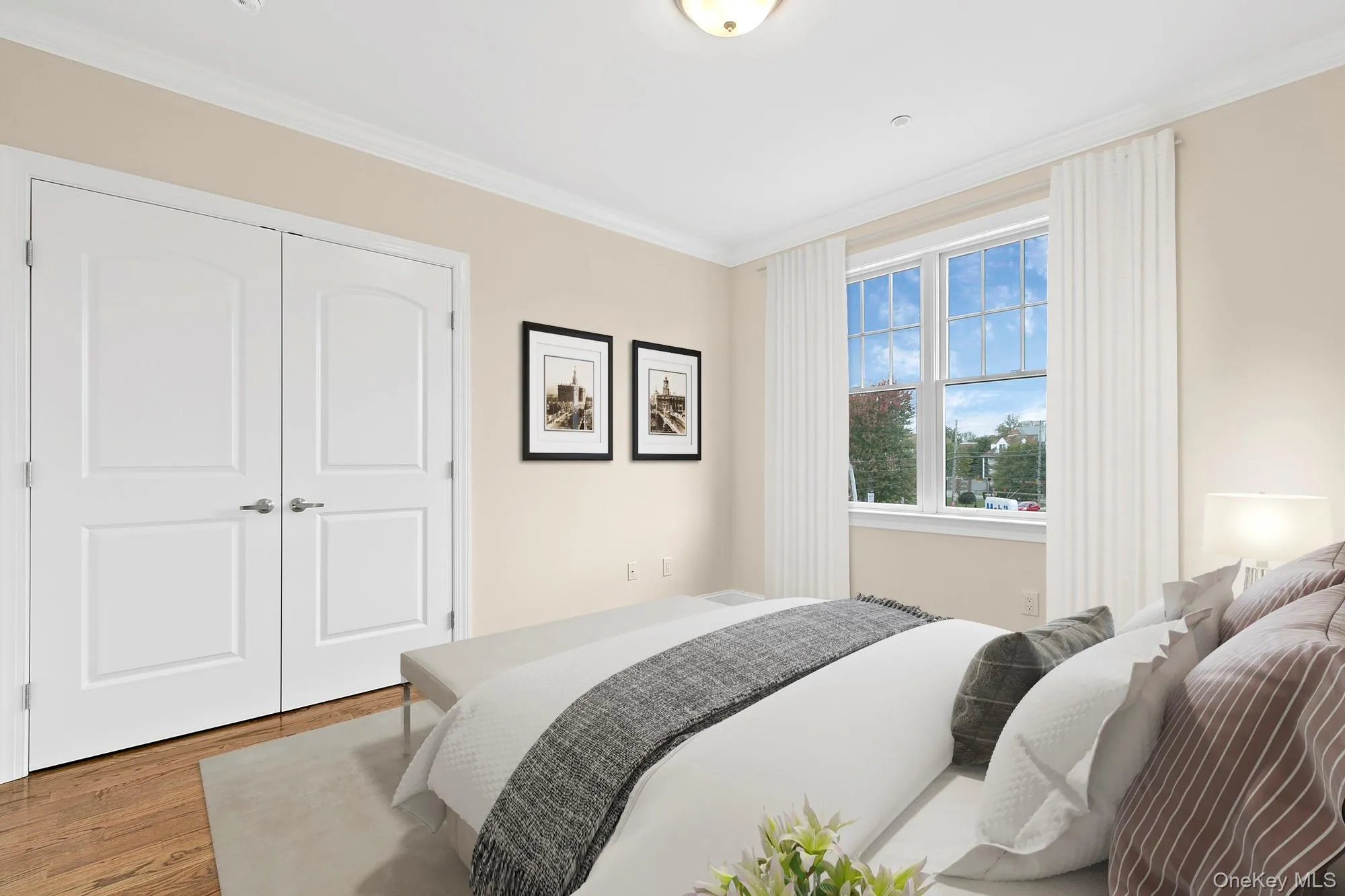 Virtually Staged -2nd Bedroom featuring crown molding, a closet, and light hardwood / wood-style floors Virtually Staged -2nd Bedroom featuring crown molding, a closet, and light hardwood / wood-style floors