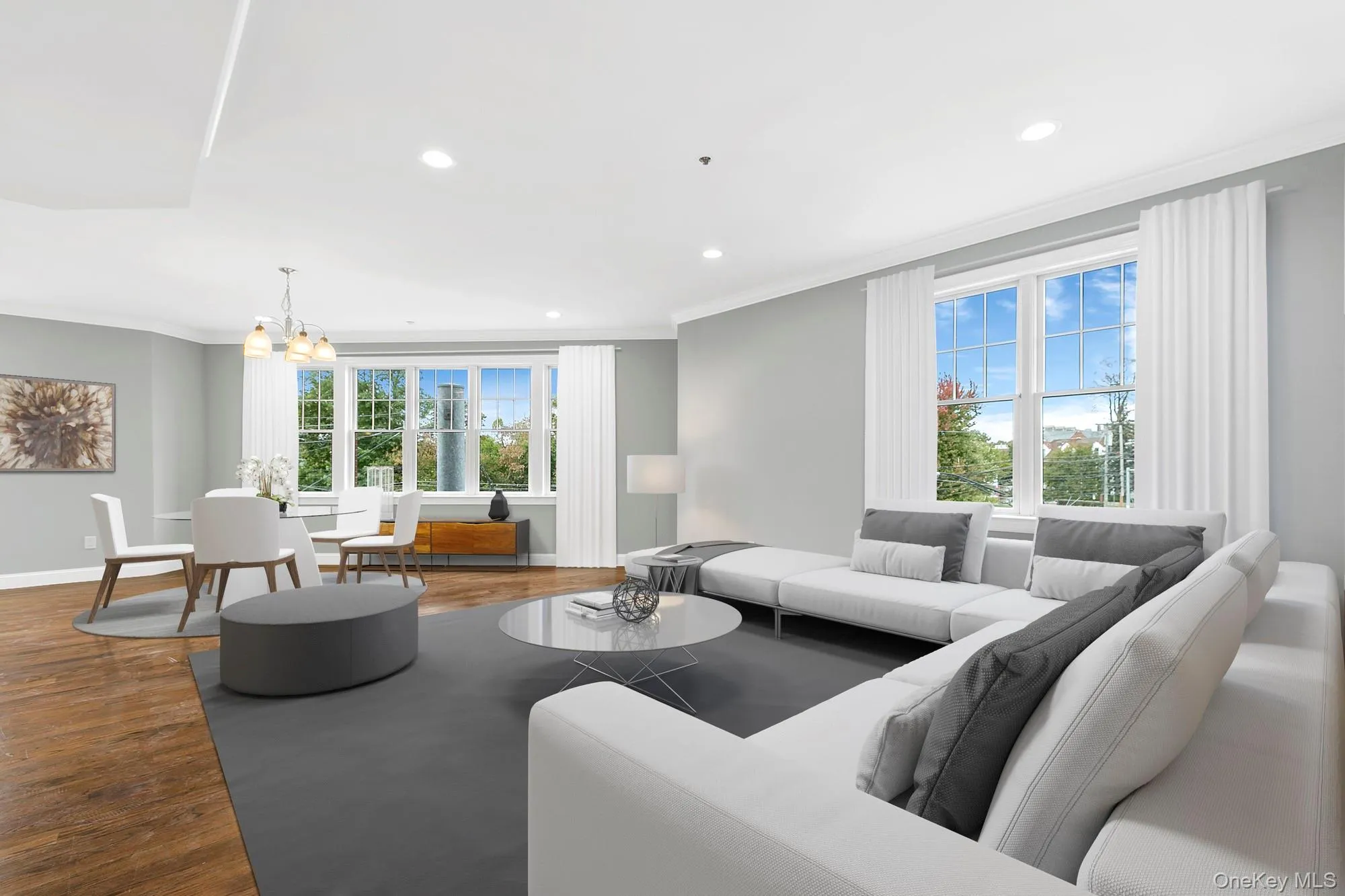 Virtually Staged - Living room featuring an inviting chandelier, hardwood / wood-style flooring, and crown molding Virtually Staged - Living room featuring an inviting chandelier, hardwood / wood-style flooring, and crown molding