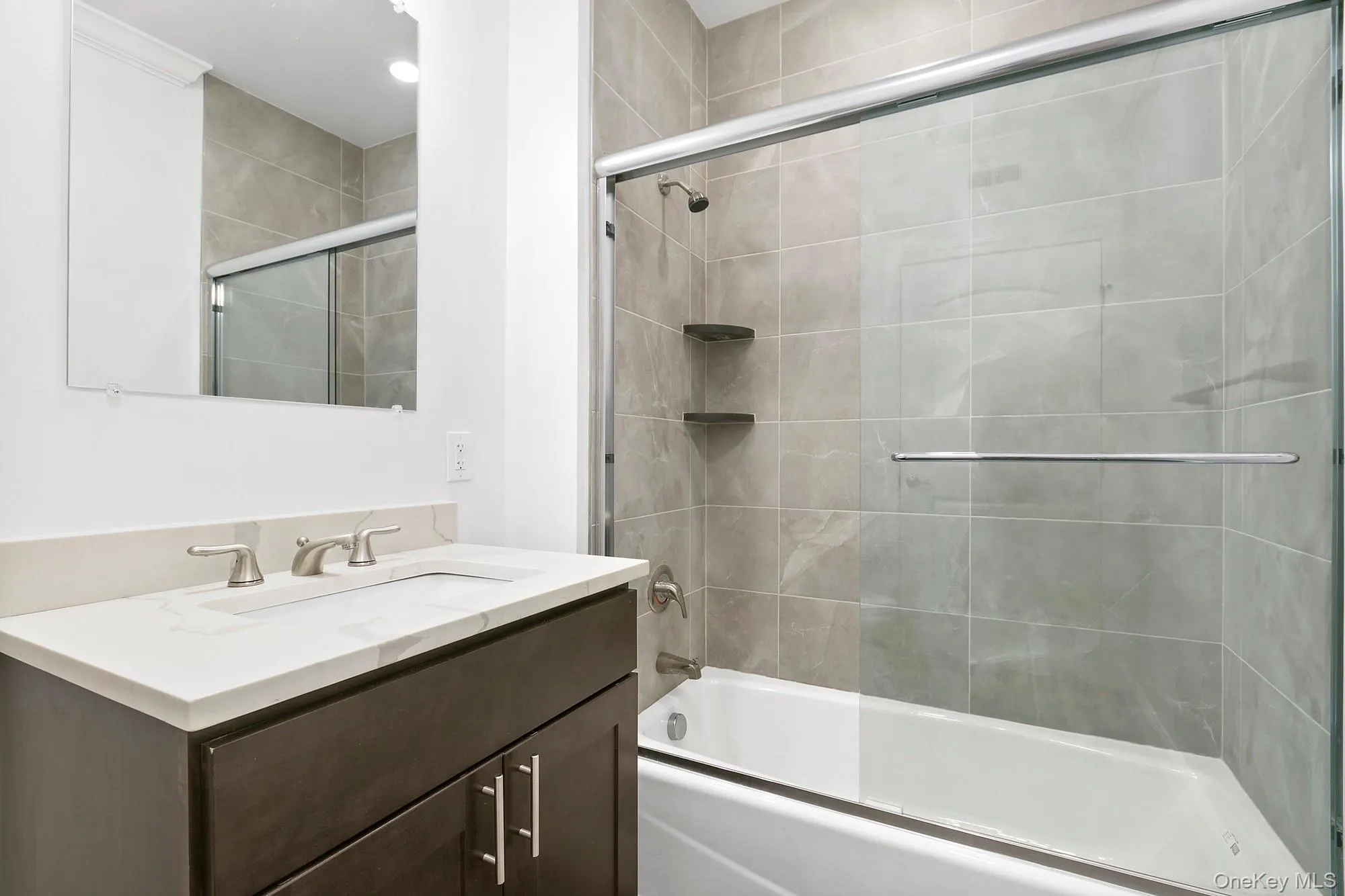 2nd or Guest Bathroom featuring enclosed tub / shower combo and vanity 2nd or Guest Bathroom featuring enclosed tub / shower combo and vanity