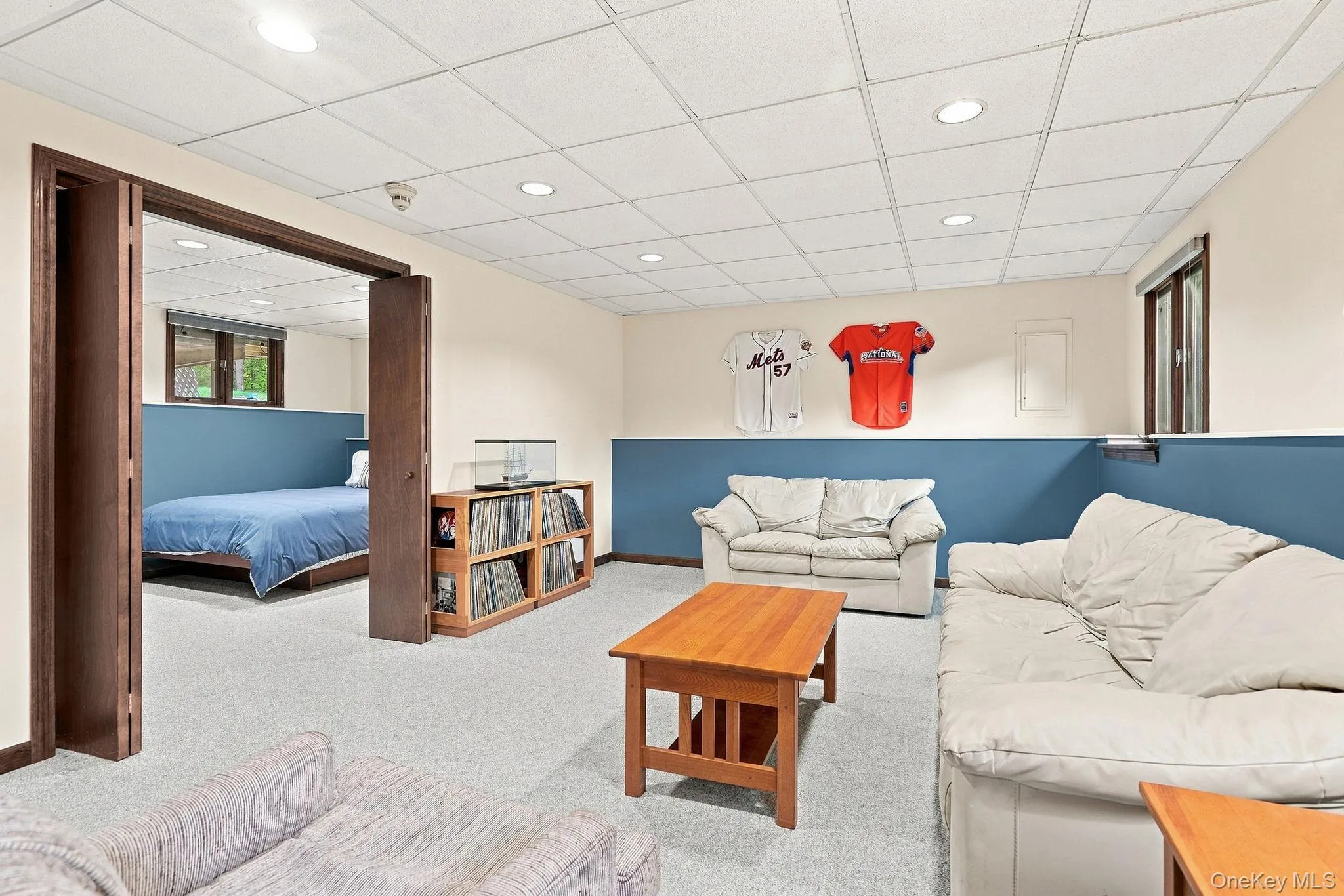 Recessed lighting, wood-finish trim, carpeting, and a drop ceiling Recessed lighting, wood-finish trim, carpeting, and a drop ceiling
