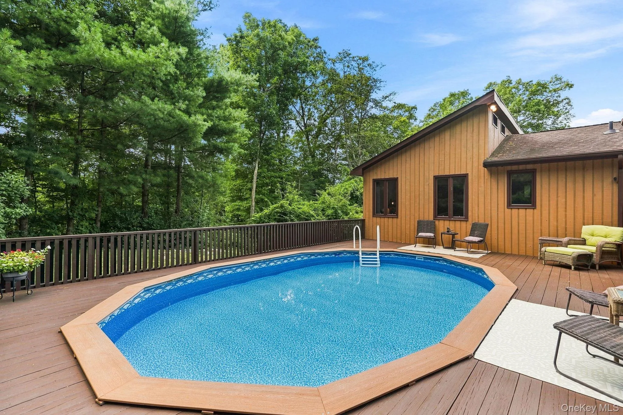 Expansive wood-finish deck with swimming pool Expansive wood-finish deck with swimming pool