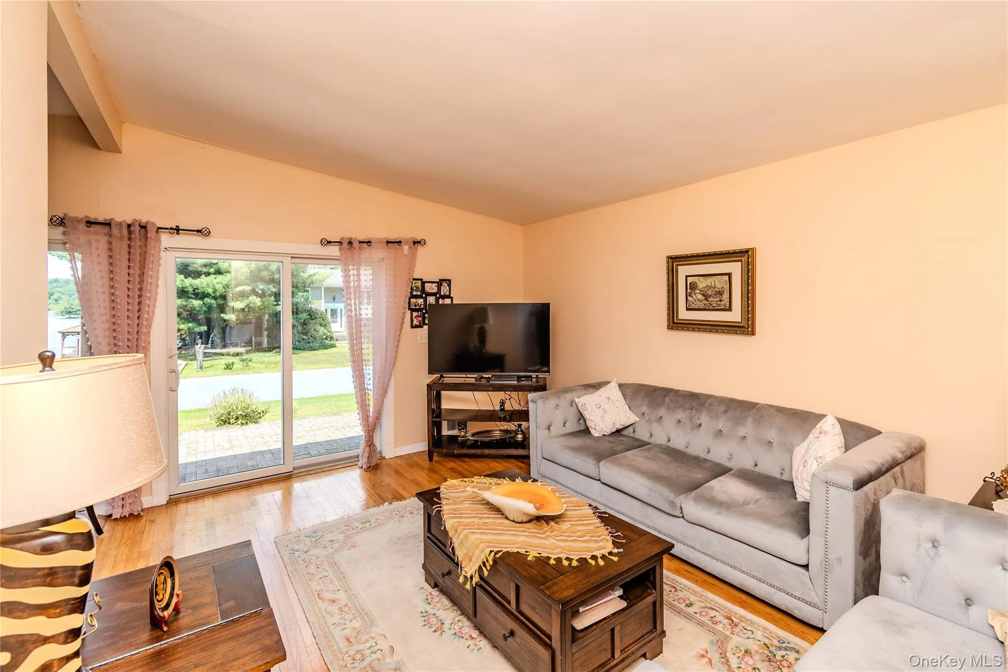 Hardwood flooring, vaulted ceiling, and sliding glass doors Hardwood flooring, vaulted ceiling, and sliding glass doors