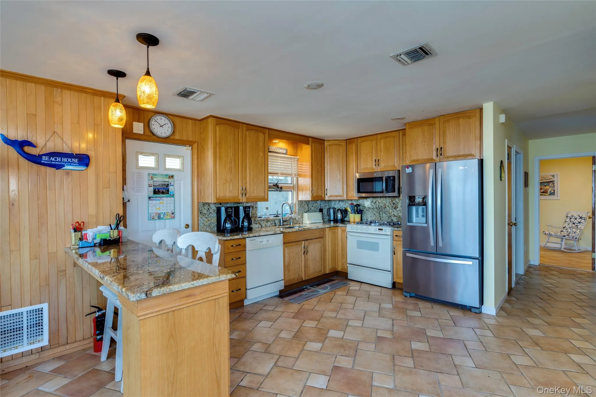 The kitchen has granite counters, wood cabinets, gas cooking, a breakfast bar and an pantry closet. The kitchen has granite counters, wood cabinets, gas cooking, a breakfast bar and an pantry closet.
