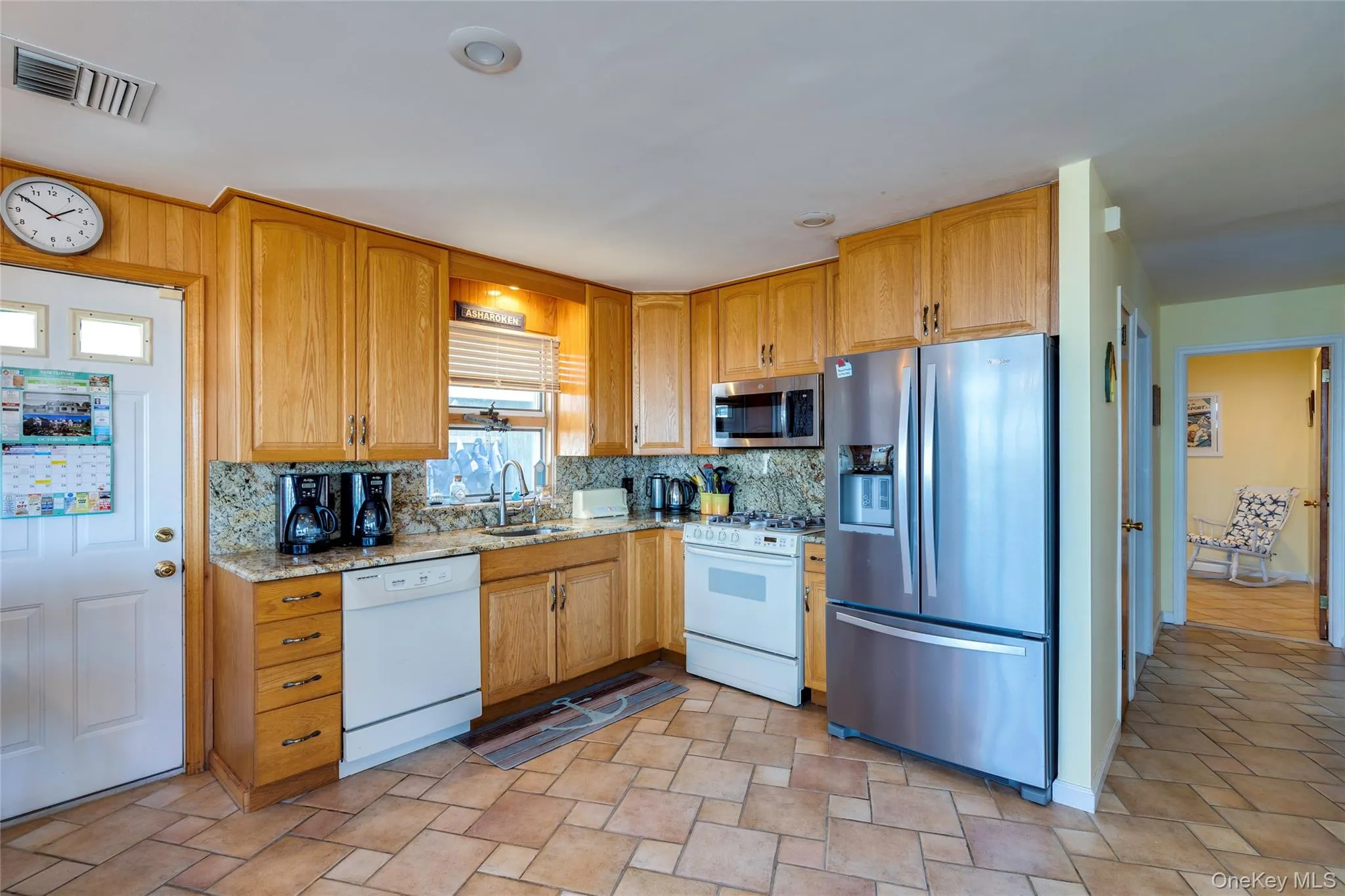 Kitchen with door to side yard. Kitchen with door to side yard.
