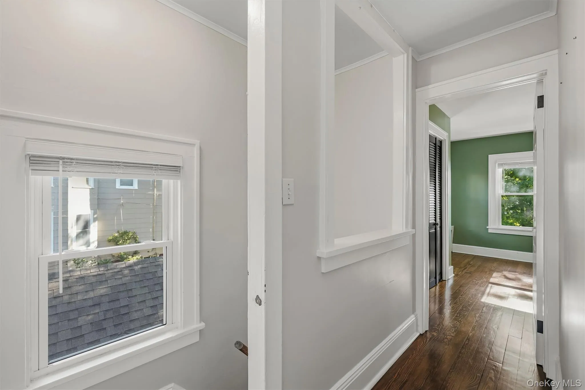 Hallway back to Dining room. Entry to basement on left Hallway back to Dining room. Entry to basement on left