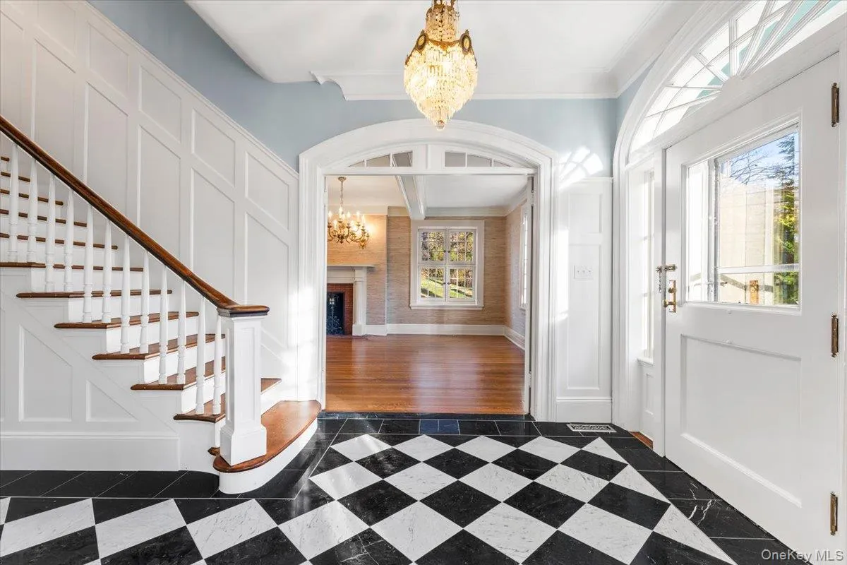 The gracious entry foyer introduces the home's beautifully preserved architectural character and checkerboard marble floor. The gracious entry foyer introduces the home's beautifully preserved architectural character and checkerboard marble floor.