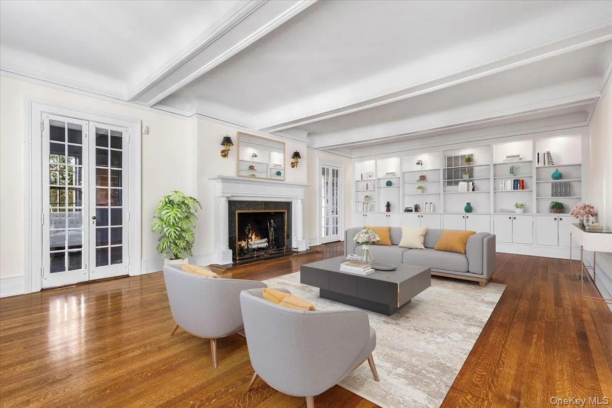 LIVING ROOMElegant living room with fireplace, custom built-ins, hardwood floors and French doors overlooking the grounds. LIVING ROOMElegant living room with fireplace, custom built-ins, hardwood floors and French doors overlooking the grounds.
